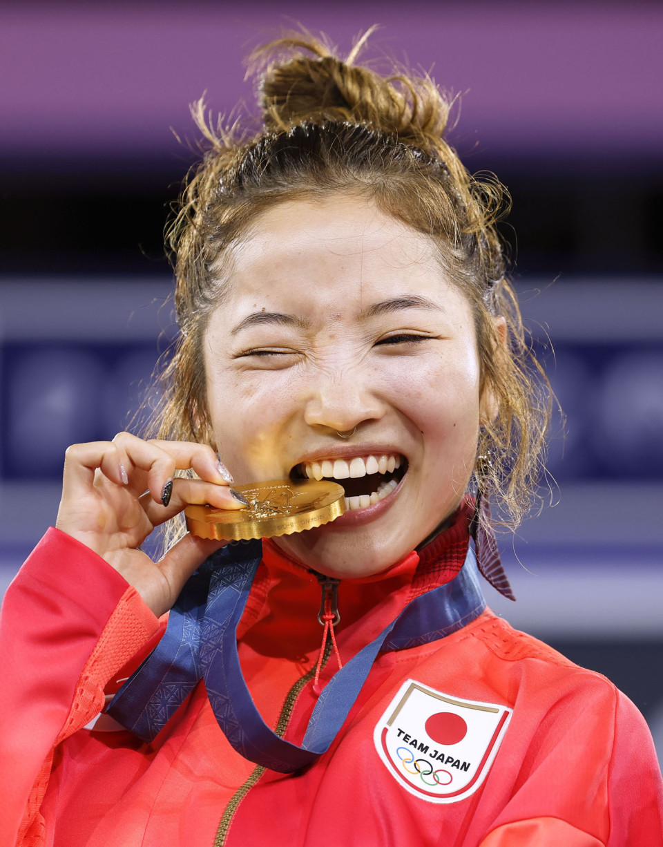 Ami takes traditional bite of the Olympic gold medal